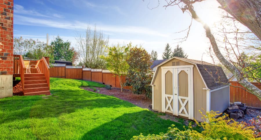 Fenced backyard with storage shed in Ithaca